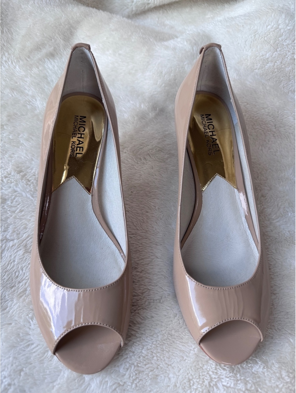 Michael Kors women’s patent leather peep-toe pumps in a classic nude/blush color